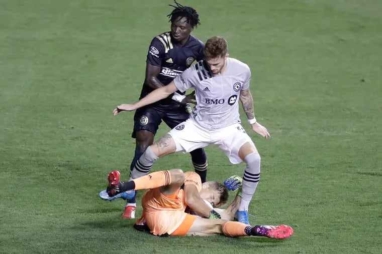 Olivier Mbaizo (rear) is expected to miss the Union's playoff game Sunday because of MLS' health and safety protocols.