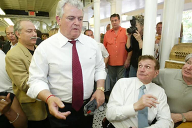 Bob Brady (left) and Tom Knox (right) cross at the Famous 4th Street Deli on Election Day.