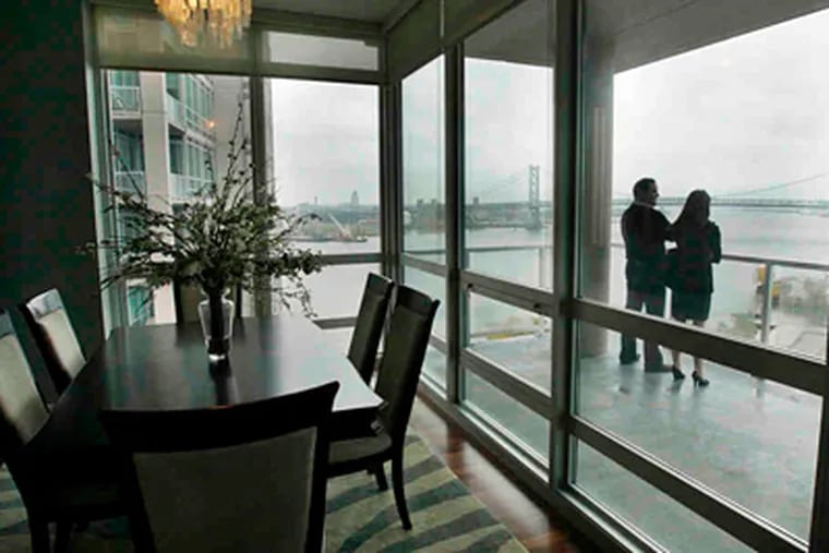 Broker Paul Lipowicz and Laura Ahmes of the auction firm on the deck of a Reef Tower Waterfront Square unit. (Elizabeth Robertson / Staff Photographer)