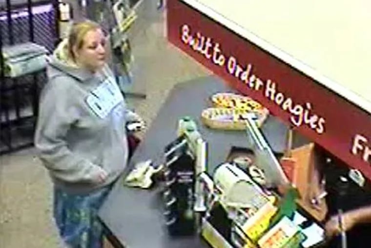 Surveillance video shows a female suspect who attempted to use a credit card owned by a robbery victim. (Photo from West Chester police)