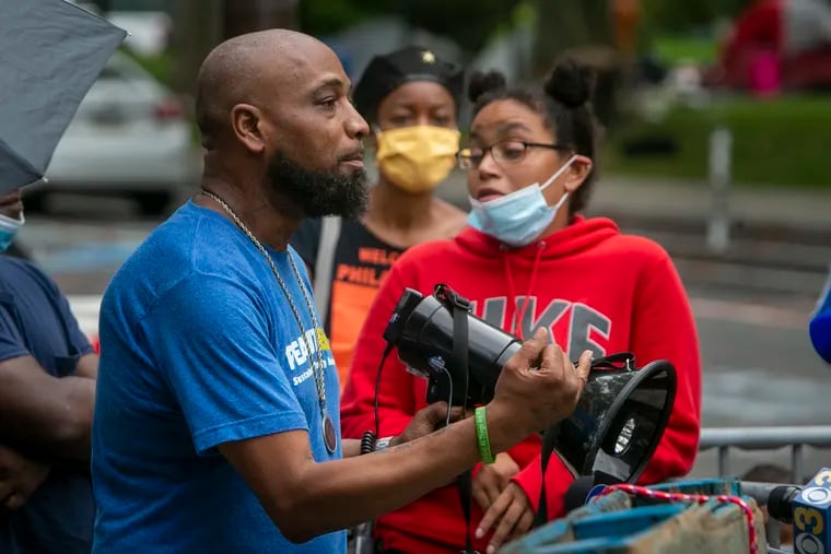 Peyton McKoy, a resident of the homeless encampment, speaks during a news conference alongside protest camp leaders on Thursday morning near 22nd Street and the Benjamin Franklin Parkway.