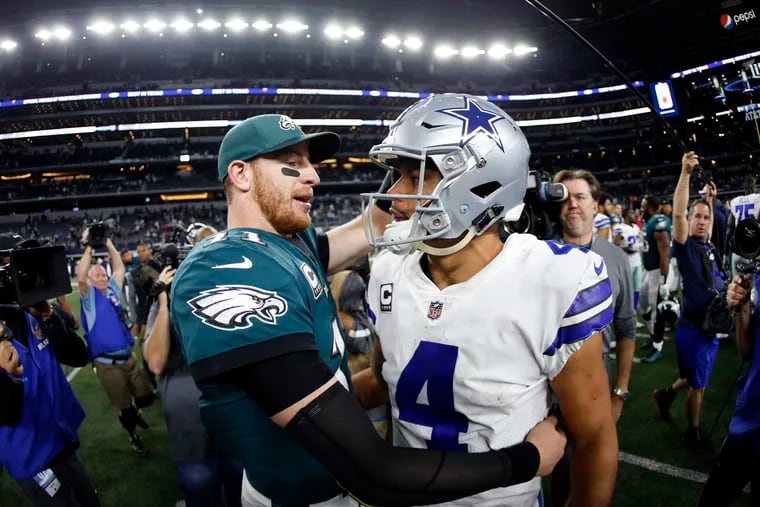 FILE - In this Nov. 19, 2017, file photo, Philadelphia Eagles' Carson Wentz, left, and Dallas Cowboys' Dak Prescott, right, greet each other after their NFL football game, in Arlington, Texas. Prescott and the Cowboys saved their season with a win in Philadelphia a month ago. Now Carson Wentz and the defending champion Eagles are trying to do the same in Texas against first-place Dallas on Sunday.