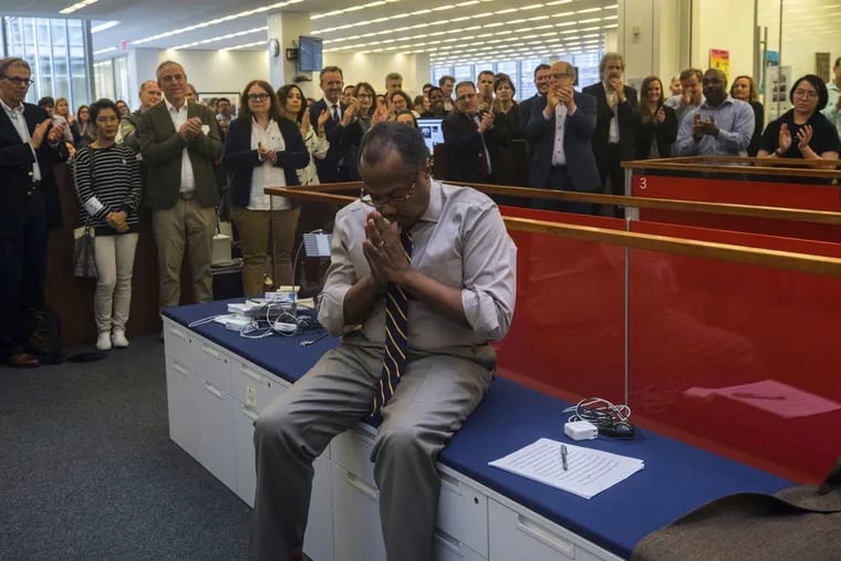 Brent Staples, a member of the New York Times editorial board, and a native of Chester, Pa., reacts as the newsroom applauds him upon the announcement that he'd won the Pulitzer Prize for editorial writing on April 15, 2019.