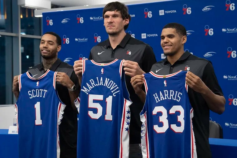 New acquired Philadelphia 76ers, Mike Scott, left, Boban Marjanovic, center, and Tobias Harris, pose for photos during an introduction press conference at the Sixers practice facility in Camden, N.J. Thursday, February 7, 2019.
