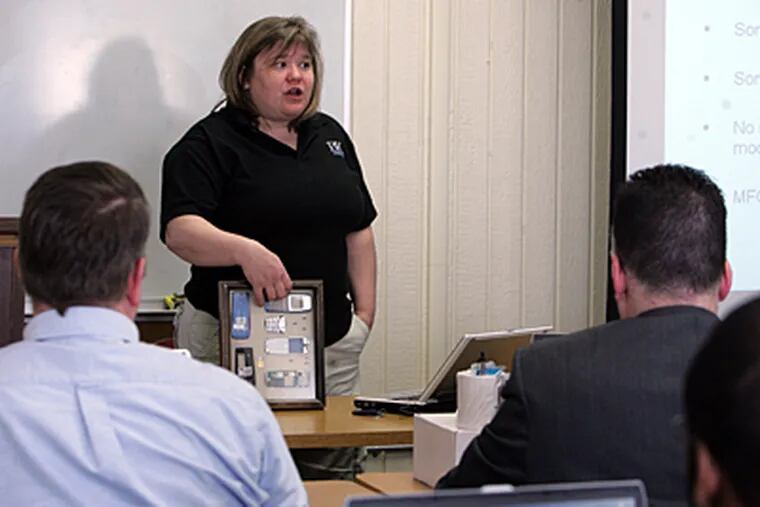 Detectives listen to Pam King of BK Forensics during a training session last month on extracting data from cell phones at the Delaware County Emergency Services Training Center in Sharon Hill. (Barbara L. Johnston/Inquirer)