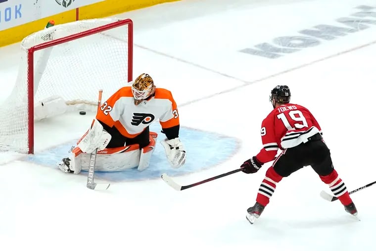 Chicago Blackhawks' Jonathan Toews (19) scores past Philadelphia Flyers goaltender Felix Sandstrom (32) during the first period of an NHL hockey game Monday, April 25, 2022, in Chicago. (AP Photo/Charles Rex Arbogast)