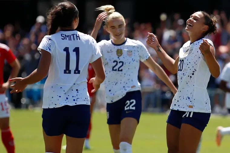 Trinity Rodman (right) celebrates with Kristie Mewis (center) and Sophia Smith after scoring one of her goals for the U.S. women's soccer team against Wales.