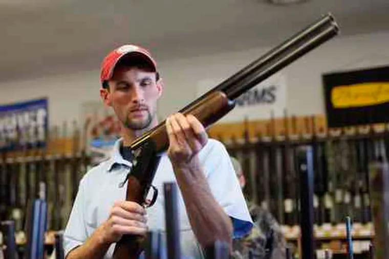 Adam Henderson shops for a rifle at Guns & Leather in Greenbrier, Tenn. The state recently eased gun laws.