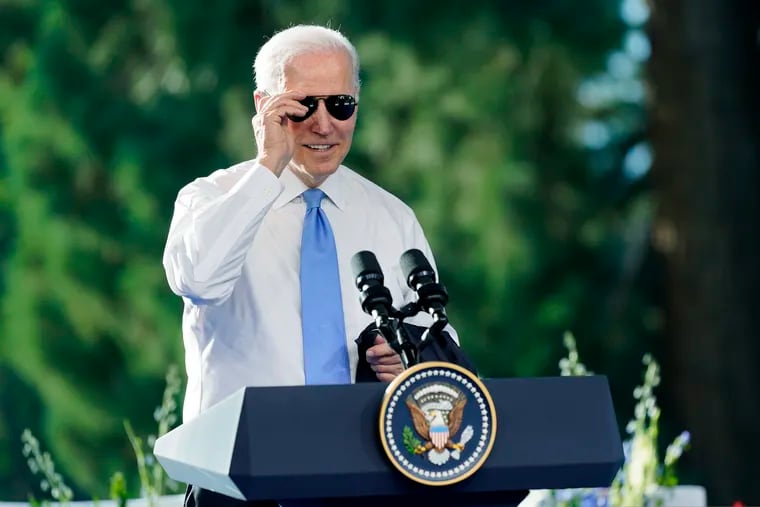 President Joe Biden puts on his sunglasses toward the end of a news conference in 2021. The president has racked up a number of accomplishments without getting much credit.