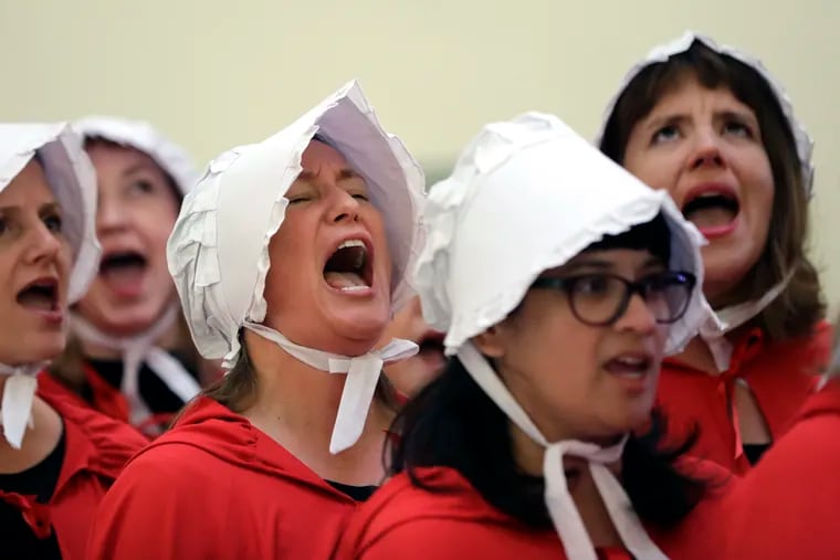 FILE - In this Tuesday, May 23, 2017 file photo, activists dressed as characters from "The Handmaid's Tale" chant in the Texas Capitol Rotunda as they protest SB8, a bill that would require health care facilities, including hospitals and abortion clinics, to bury or cremate any fetal remains whether from abortion, miscarriage or stillbirth, and they would be banned from donating aborted fetal tissue to medical researchers in Austin. Tissue left over from elective abortions has been used in scientific research for decades, and is credited with leading to lifesaving vaccines and other advances. (AP Photo/Eric Gay)