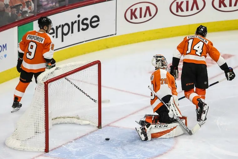Flyers goalie Carter Hart, Ivan Provorov (9) and Sean Couturier (14) react after the Blues' Brayden Schenn scored during the second period of at the Wells Fargo Center.