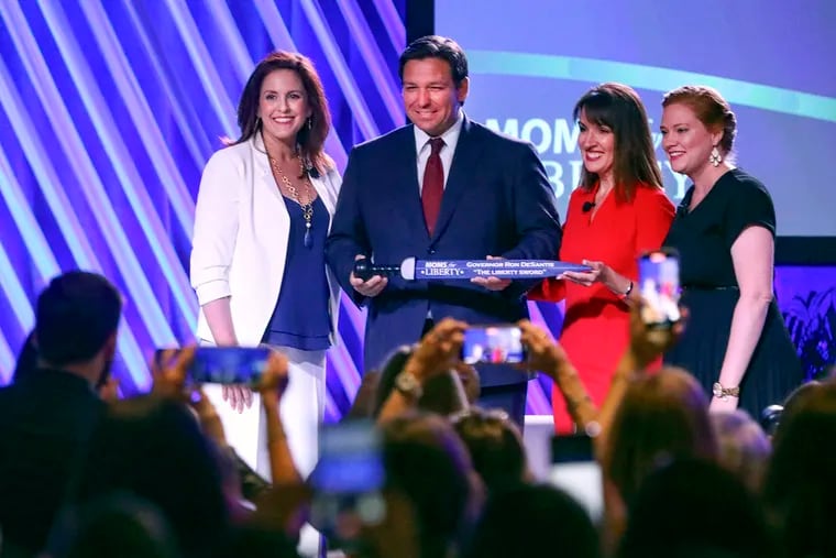 Florida Gov. Ron DeSantis is presented with "The Liberty Sword" during the Moms for Liberty National Summit on July 15, 2022, in Tampa, Fla.