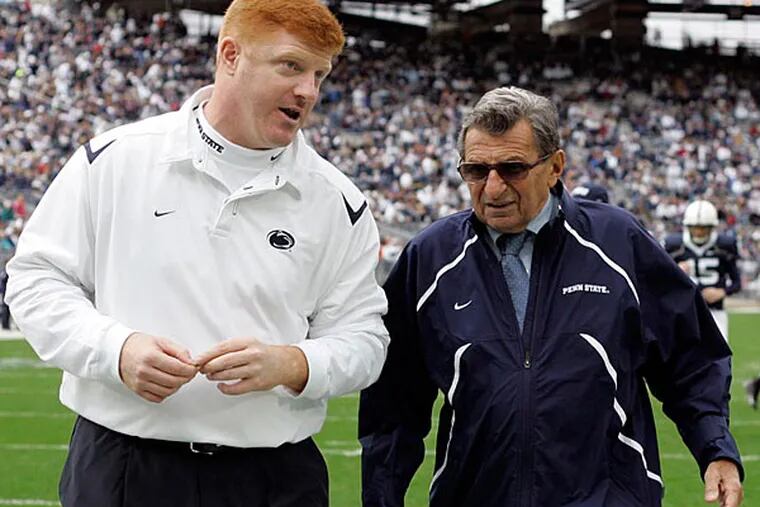 FILE - In this Oct. 10, 2009 file photo, Penn State coach Joe Paterno, right, and assistant coach Mike McQueary walk off the field together before an NCAA college football game against Eastern Illinois in State College, Pa. On Sunday, Jan. 22, 2012, family says Paterno, winningest coach in major college football, has died. (AP Photo/Carolyn Kaster, File)