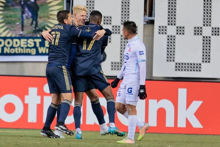 Damion Lowe (center) celebrates with Alejandro Bedoya (left) and Jakob Glesnes (second from left) after scoring the Union's opening goal.