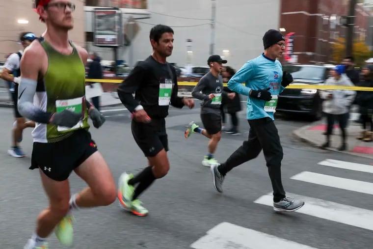Runners head down Walnut Street during the AACR Philadelphia Marathon Nov. 21, 2021. Scientists are learning more about the coveted "runner's high."