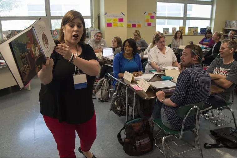 Stacy Dougherty, a kindergarten teacher at Clara Barton ES, leads a class of fellow elementary school teachers in how to Read Aloud and Shared Reading During the Literacy Block  during a Philadelphia School District training program for K-3 teachers on early literacy instruction.