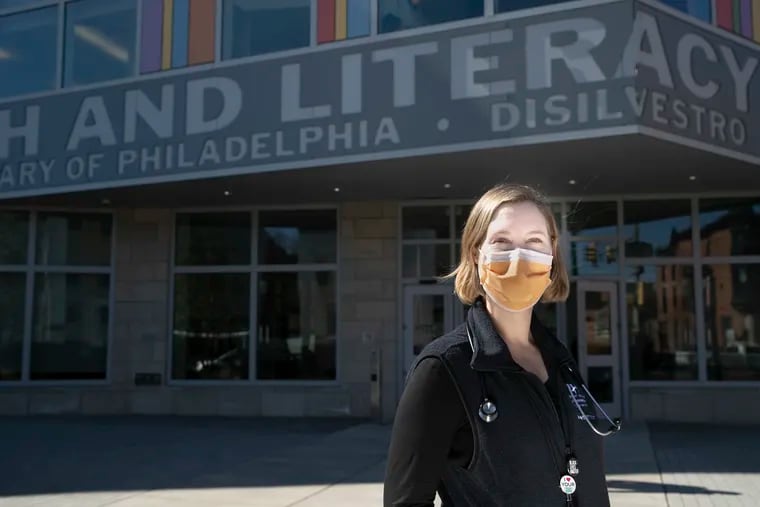 Katie Lockwood poses for a portrait outside of CHOP Primary Care at the corner of Broad and Morris Streets in South Philadelphia on Feb. 25, 2021.