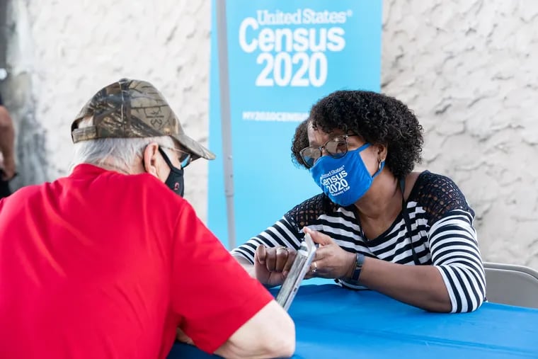 Renee Lee (right) helps James Pfeffer to enter his census information at a census outreach event in Paulsboro, Gloucester County.