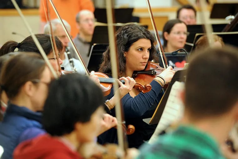 Katrina Christoforidis of Drexel Hill, second violinist, rehearses with other members of the Lansdowne Symphony at Temple Adath Israel in Merion. The 80 or so players get together weekly.