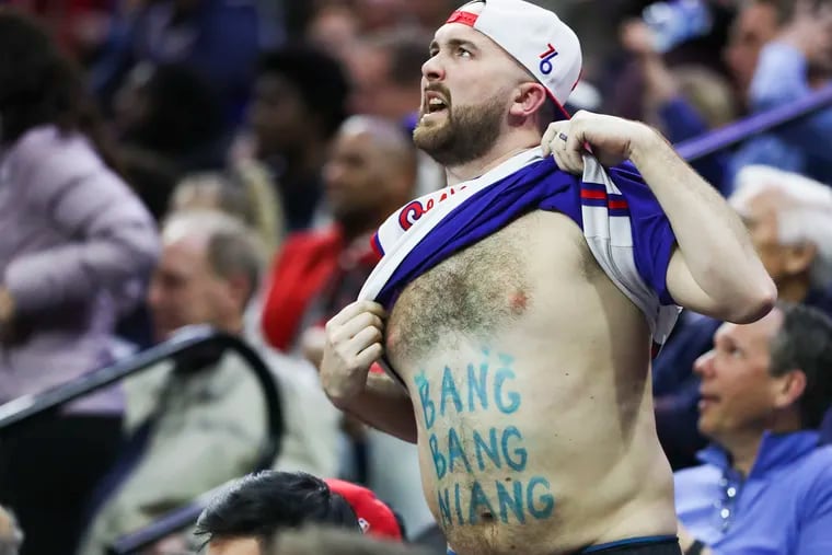 A Sixers fan shows off a “Bang Bang Niang” belly in the second half of a game at the Wells Fargo Center in Philadelphia on Wednesday, March 29, 2023.