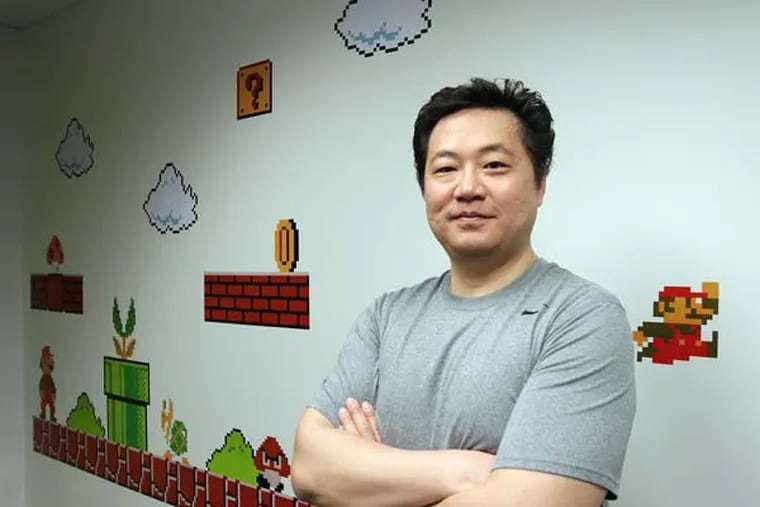 Drexel University professor Frank Lee, who co-founded the school's highly regarded Game Design Program. Lee is the guy who dreamed of turning the Cira Centre into a giant game display -- last year for Pong, this year for Tetris. He is pictured in Drexel University's Excite Center Game Design Program studio in Philadelphia on April 2, 2014.  ( DAVID MAIALETTI / Staff Photographer )