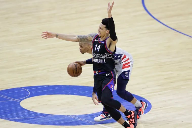 Washington Wizards guard Russell Westbrook commits a third-quarter offensive foul against Sixers forward Danny Green during Game 1.