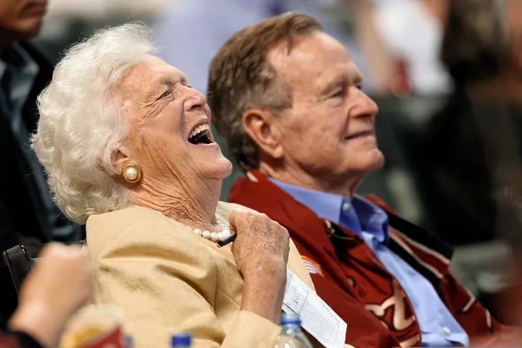 In this April 18, 2009, file photo, Barbara Bush laughs alongside former President George H.W. Bush, right, as they attend a baseball game in Houston.