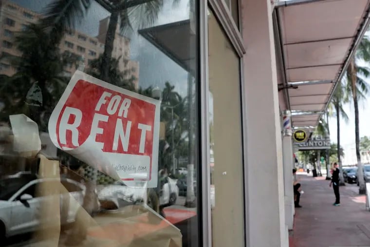 In this July 13 photo, a "For Rent" sign hangs on a closed shop in Miami Beach, Fla.