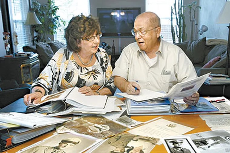 Gini Doolittle (left) and Bob Frantz look over photos and memorabilia of their relatives who were killed in World War II. Doolittle lost a second cousin, Lt. Joseph J. Auld, and Frantz lost a brother, Clarence Frantz, when a C-47 cargo plane crashed during a supply run over Burma in 1944. (Michael S. Wirtz / Staff Photographer)