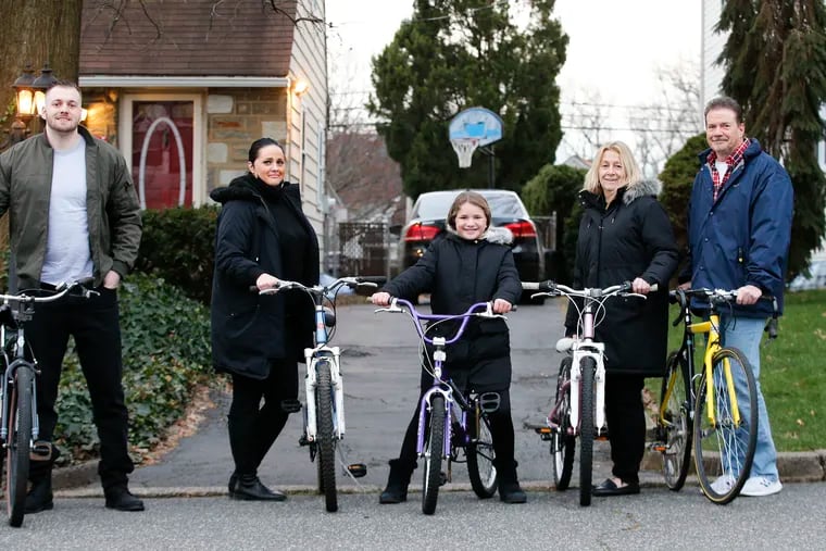 The Guinan family (from left to right): Christian, Lauren, Sophia, Cindy and Chris on some of the refurbished bikes at their Northeast Philadelphia home on Friday, January 8, 2021.  The Guinan family have been collecting bikes for some years, fixing them up and donating them to nonprofits for kids and needy adults.