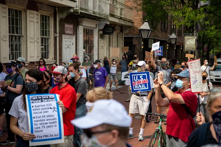 Postal workers and community members rally to save the U.S. Postal Service Saturday in front of the historic Benjamin Franklin Post Office on Market Street in Old City.