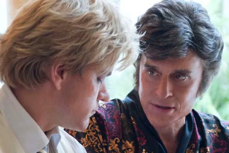 Caption: Matt Damon and Michael Douglas star as Scott Thorson and his longtime lover Liberace in HBO’s “Behind the Candelabra”  Claudette Barius/HBO