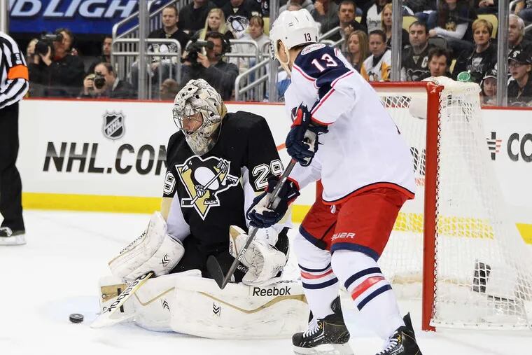 Penguins goalie Marc-Andre Fleury stops a shot by the Blue Jackets' Cam Atkinson. Matt Calvert scored the game-winner as Columbus prevailed, 4-3, in double overtime.