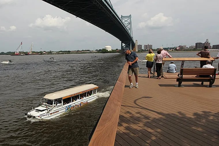 A Duck Boat slides by the Race Street Pier on its way to its ramp out of the Delaware River. Philly banned the amphibious vehicles after a fatal accident.  The company that owns a duck boat that sank on a Missouri lake last summer, killing 17 people, announced Thursday that it won't operate the vessels this year because of the ongoing investigation and will instead open a replacement attraction in the tourist town of Branson. (Michael Bryant / Staff Photographer)