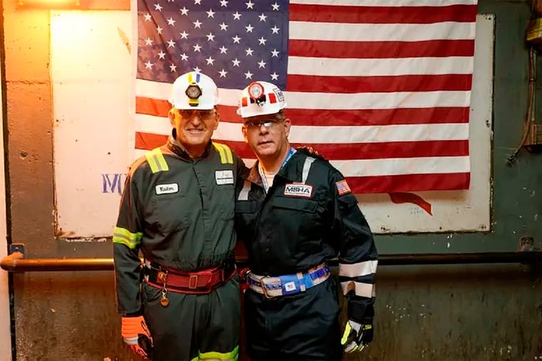 In this photo released by the Office of U.S. Sen. Joe Manchin (D. W.Va.), Manchin (left) poses with U.S. Labor Secretary Marty Walsh during a tour of an underground coal mine, in Dallas, W.Va., in August.