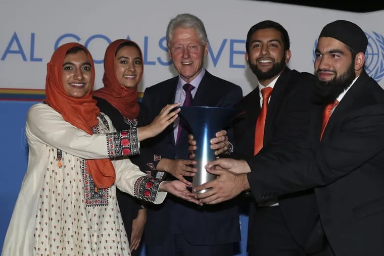Former President Bill Clinton (center) poses with the members of the winning team from Rutgers University during the Hult Prize Finals and Awards Dinner on Saturday, Sept. 16, 2017, at the United Nations headquarters in New York. From left: Gia Farooqi, Hanaa Lakhani, Clinton, Moneed Mian, and Hasan Usmani.