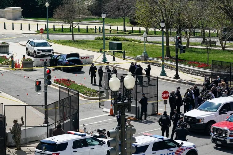 U.S. Capitol Police officers investigating near the car that crashed into a barrier on Capitol Hill near the Senate side of the Capitol on Friday.