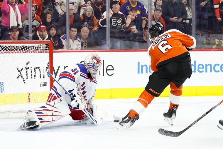 Flyers defenseman Travis Sanheim skates with the puck during a third period short-handed scoring attempt against New York Rangers goaltender Igor Shesterkin on Feb. 24.