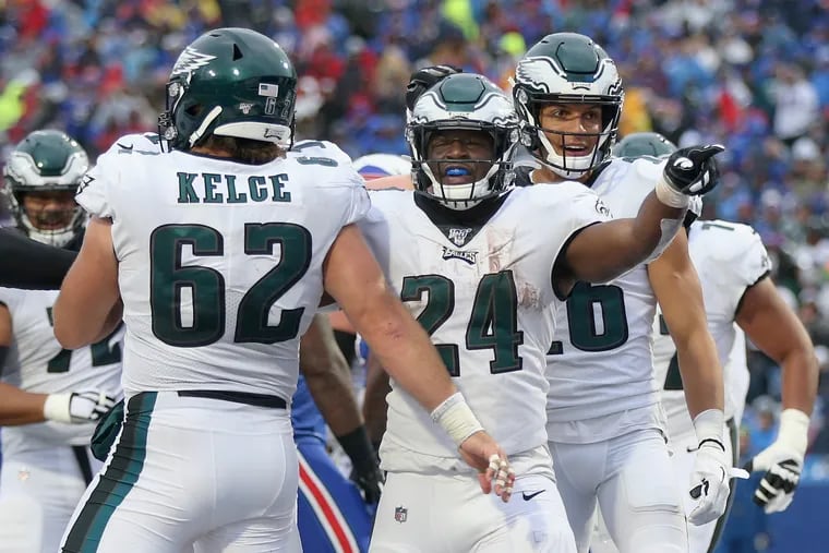 Eagles running back Jordan Howard (24) celebrates his fourth-quarter touchdown with center Jason Kelce (62) during a game against the Buffalo Bills at New Era Field in Orchard Park, N.Y., on Sunday, Oct. 27, 2019.