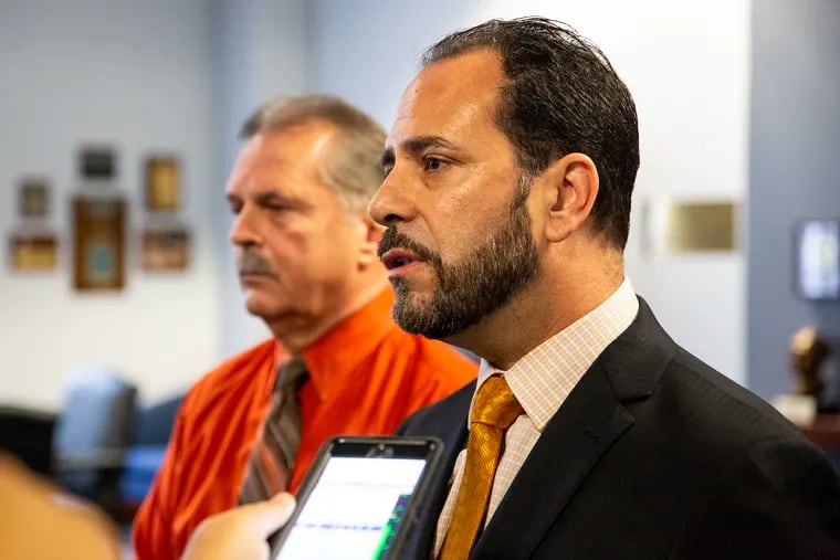 File photo: Former Bordentown Township Police Chief Frank Nucera Jr. (left) listens as his attorney Rocco Cipparone speaks to reporters following a mistrial in October in his federal hate-crime assault case.