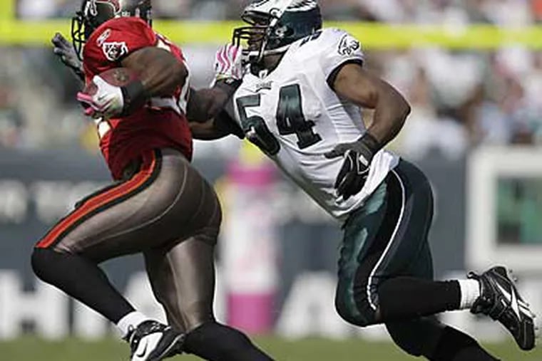 Jeremiah Trotter, right, goes for a tackle on Tampa Bay running back Carnell Williams in his first game back with the Eagles. (David Maialetti / Staff Photographer)