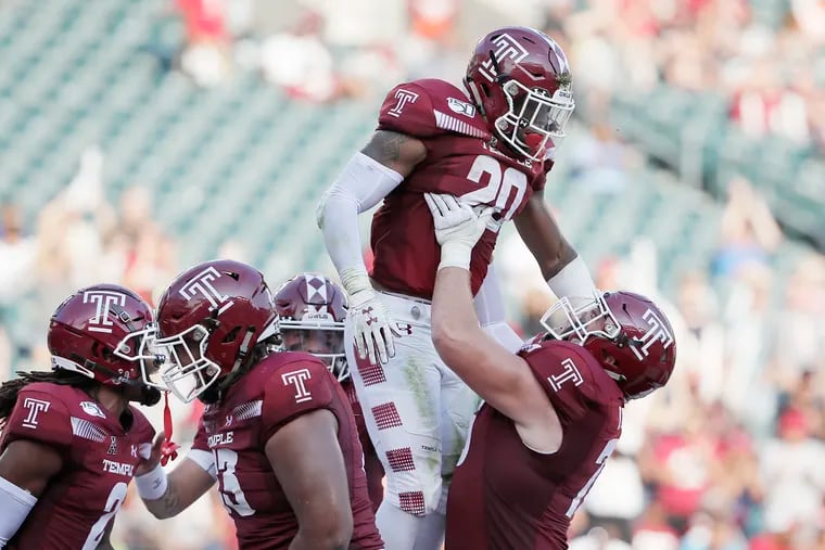 Temple's Re’Mahn Davis is held up by teammate Vincent Picozzi after Davis scored Temple’s first touchdown against Georgia Tech.