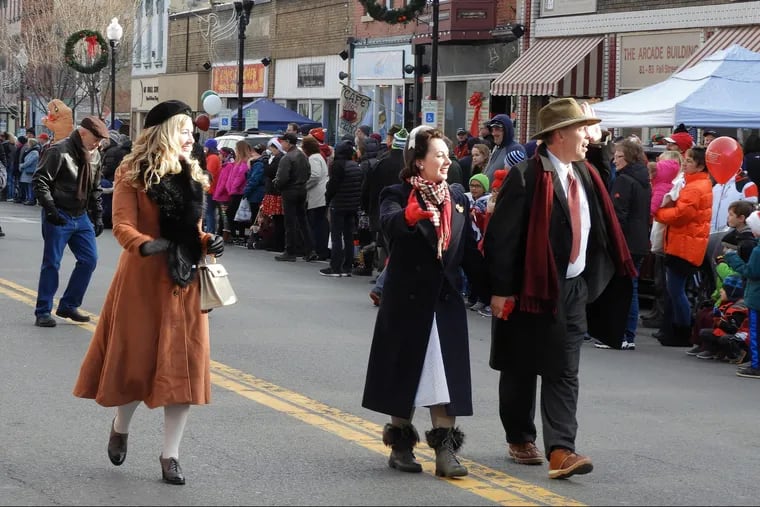 Locals dressed as characters from "It's  a Wonderful Life"  greet the crowd as they walk through downtown Seneca Falls, N.Y.,  during the 2017 festival parade.