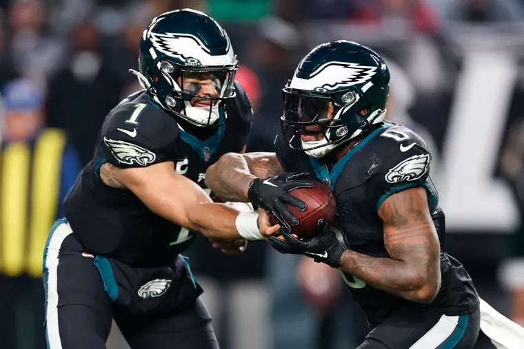 Eagles quarterback Jalen Hurts hands-off the football to running back D'Andre Swift in the third quarter against the New York Giants on Monday, December 25, 2023 in Philadelphia