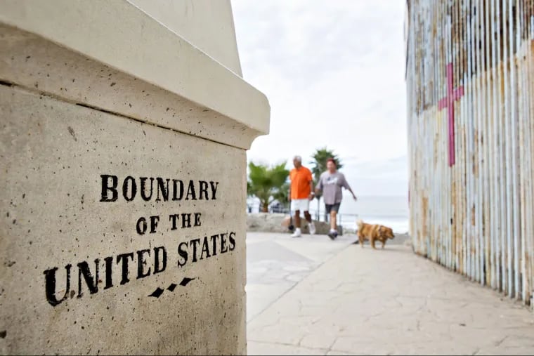 A boundary monument stands along the U.S.-Mexico border fence in Tijuana, Mexico.