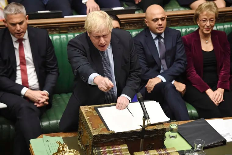 Britain's Prime Minister Boris Johnson speaks to lawmakers inside the House of Commons to update details of his new Brexit deal with EU, in London Saturday Oct. 19, 2019. At a rare weekend sitting of Parliament, Johnson implored legislators to ratify the Brexit deal he struck this week with the other 27 EU leaders. Secretary of State for Exiting the European Union, Stephen Barclay, left, and Business Secretary Andrea Leadsom, right.