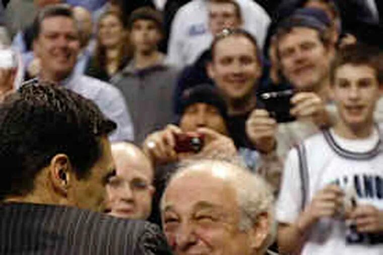 Jay Wright is congratulated by former coach Rollie Massimino (right) after Saturday's last-second victory over Pittsburgh. Wright has openly embraced the Wildcats' past.