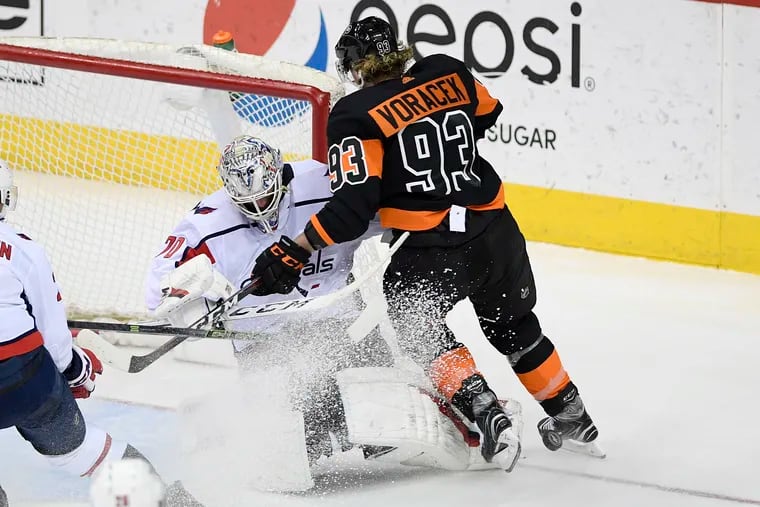 Washington goaltender Braden Holtby stops the Flyers' Jake Voracek during the Capitals' 3-1 win Sunday. Voracek scored the Flyers' lone goal.