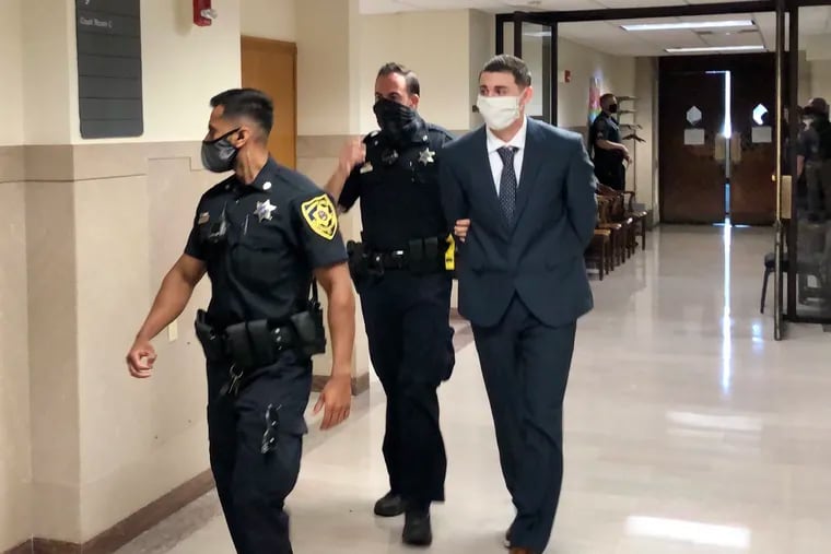 Gilbert Newton III is escorted out of a courtroom in the Montgomery County Courthouse. Newton was convicted of first-degree murder in the killing of his ex-girlfriend, Morgan McCaffery, during an argument in July 2020.