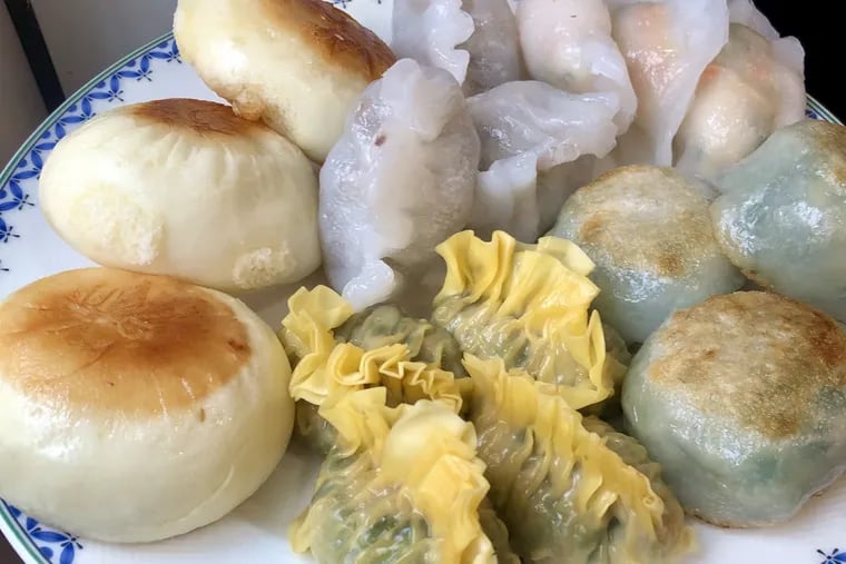 A selection of dim sum from China Gourmet in Northeast Philadelphia includes, clockwise from top, pan fried pork buns, steamed fan kor filled with pork and peanuts, mixed seafood dumplings, chive dumplings.